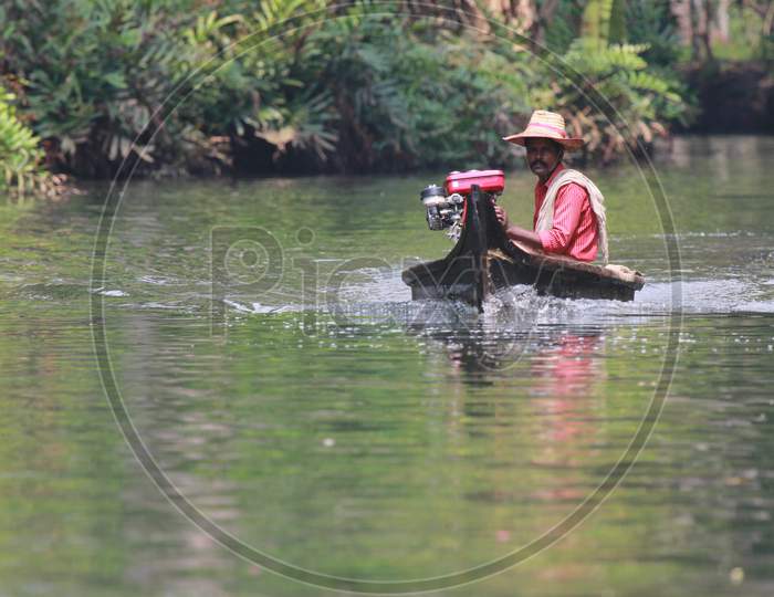 Indian Man Rowing the Boat in Kerala