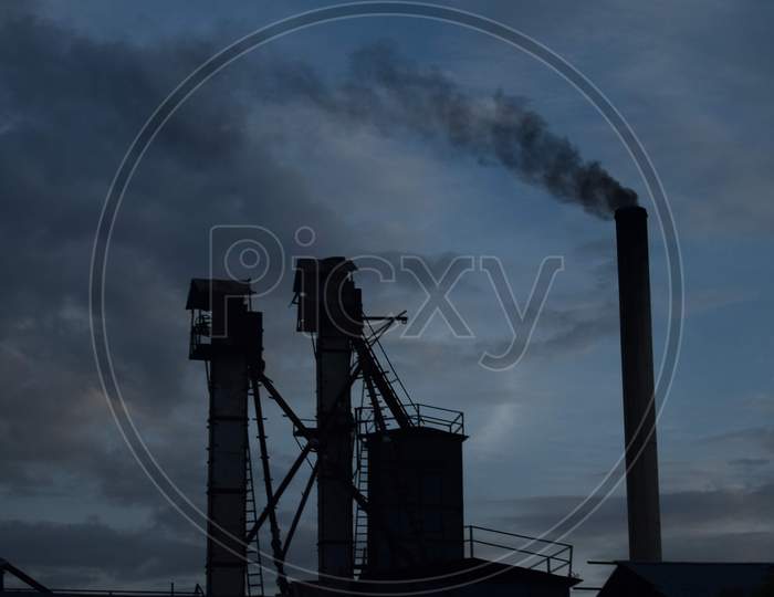 Silhouette Of Vent Pipes With Smoke
