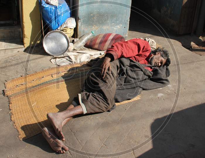 A Beggar Sleeping on the Road in Mumbai Streets