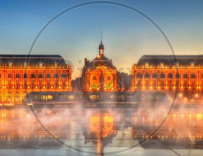 Iconic View Of Place De La Bourse With Tram And Water Mirror Fountain In Bordeaux, France