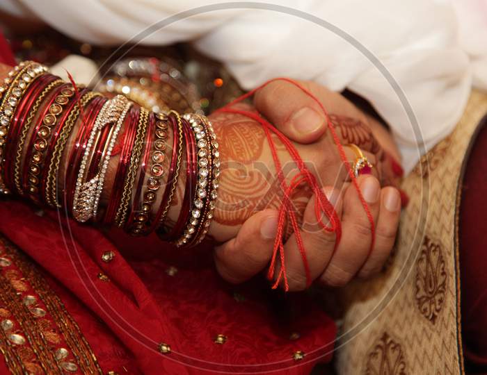 Indian Traditional Marriage Scenes With Bride And Bridegroom Holding Hands During Wedding Rituals