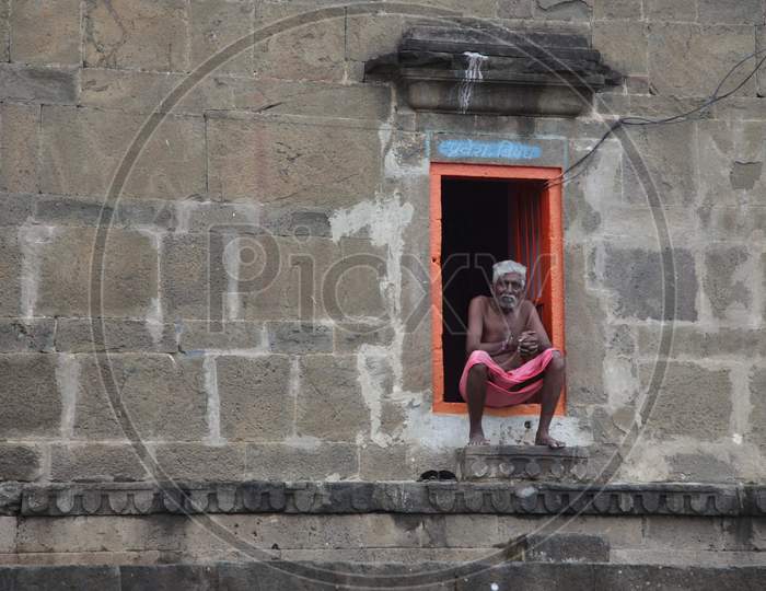 Indian Old Man sat outside House in Maheshwar, Madhya Pradesh, India
