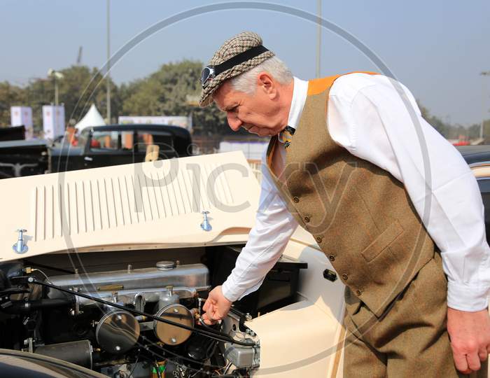 A Foreign man checking the Retro Benz Car