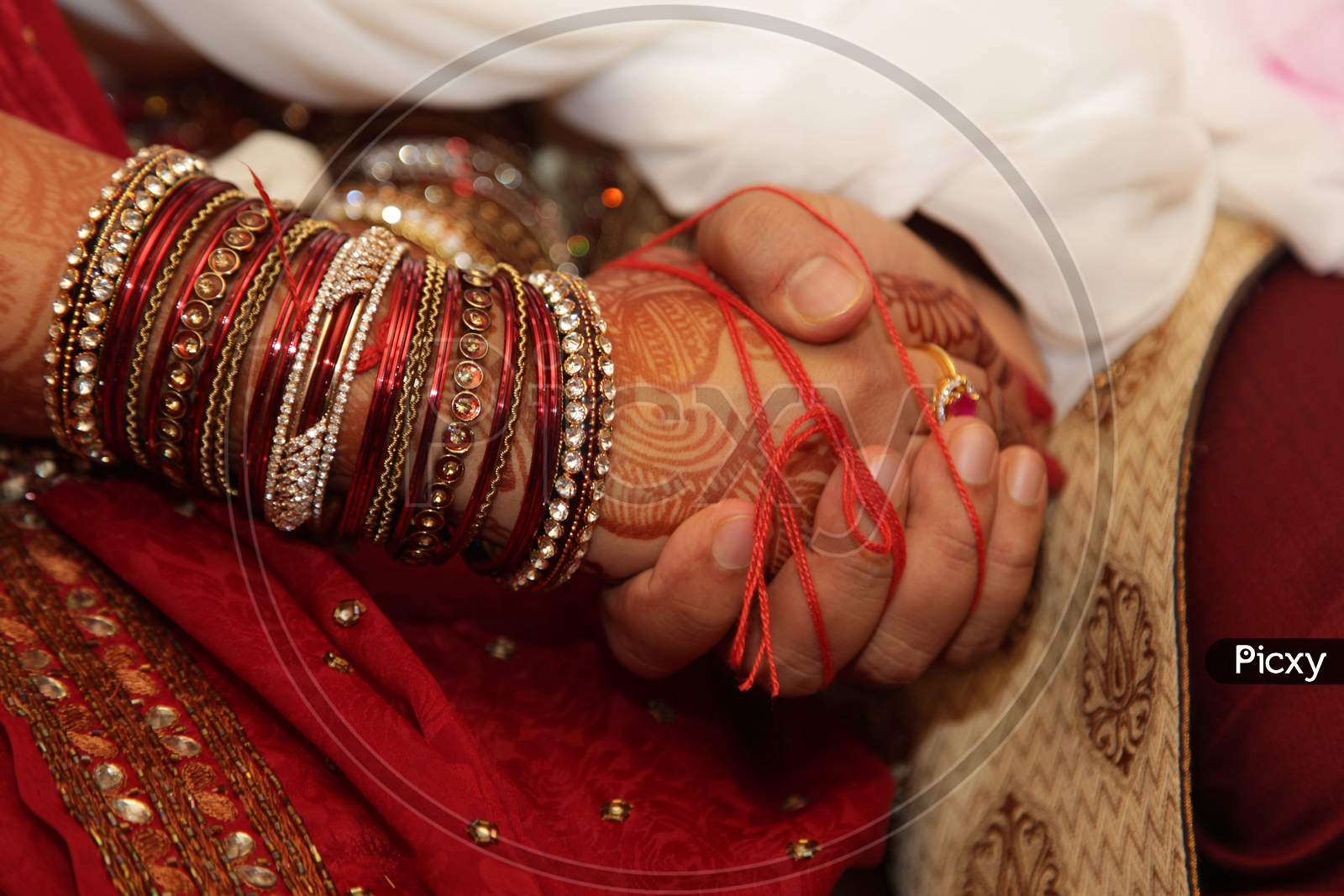 Indian Traditional Marriage Scenes With Bride And Bridegroom Holding Hands During Wedding Rituals