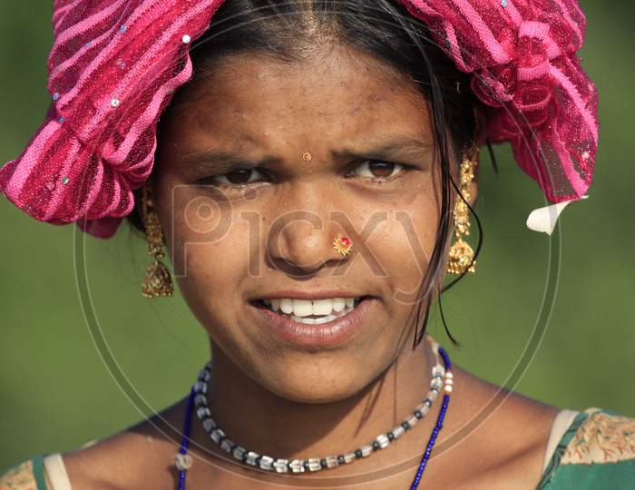 Indian Tribal Woman Carrying Grass From  Forests In Tribal Villages Of India