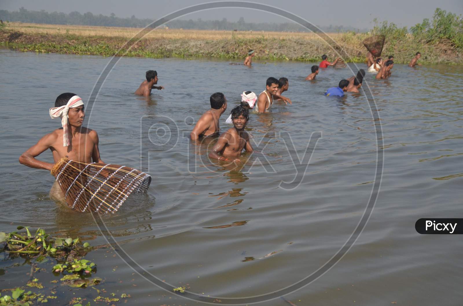 Indian villagers participate in community fishing during the Bhogali Bihu or Magh Bihu celebration at Phuloguri village in Nagaon district of northeastern Assam state on January 14, 2015.