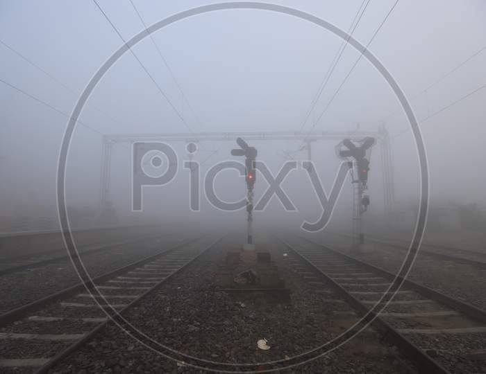 People Crossing Railway Track on a Misty Mornings