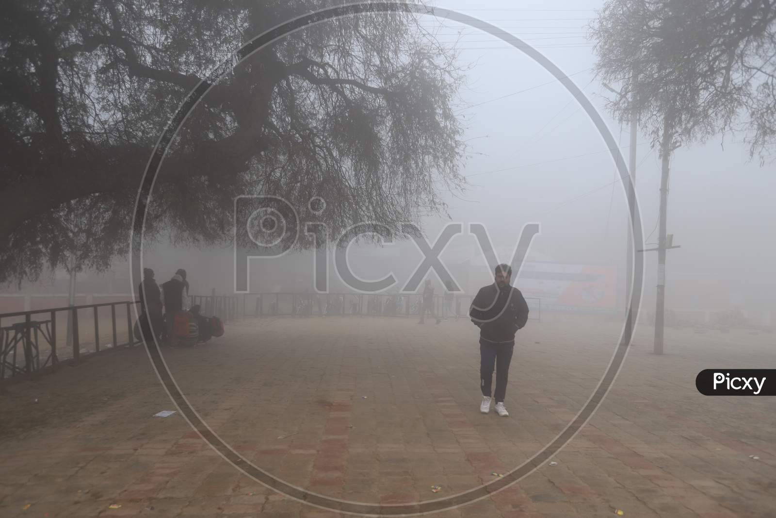 A Man Walking By Wearing Track suit In Morning Mist
