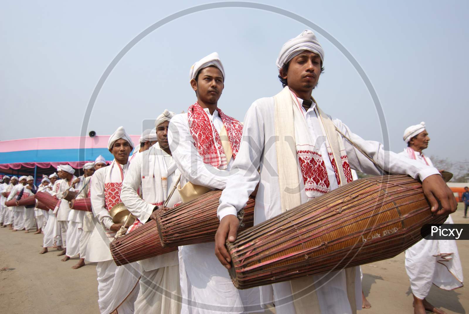 Artists Playing Dholak or Drums in Bihu Festival Celebrations