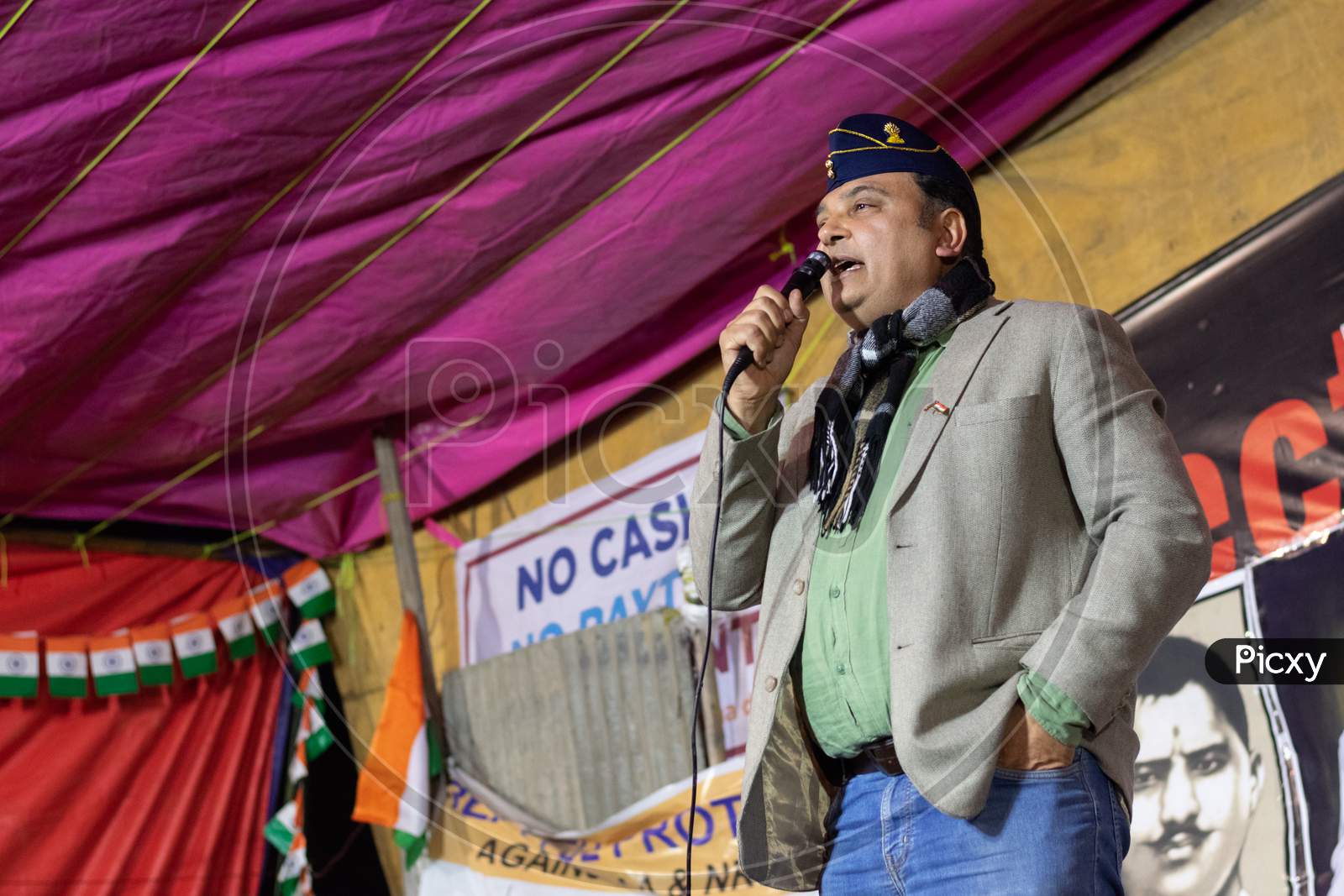 A man speaking on stage at shaheen Bagh during protest against Citizenship Amendment Act CAA, National Register Of Citizens NRC and National Population Register NPR