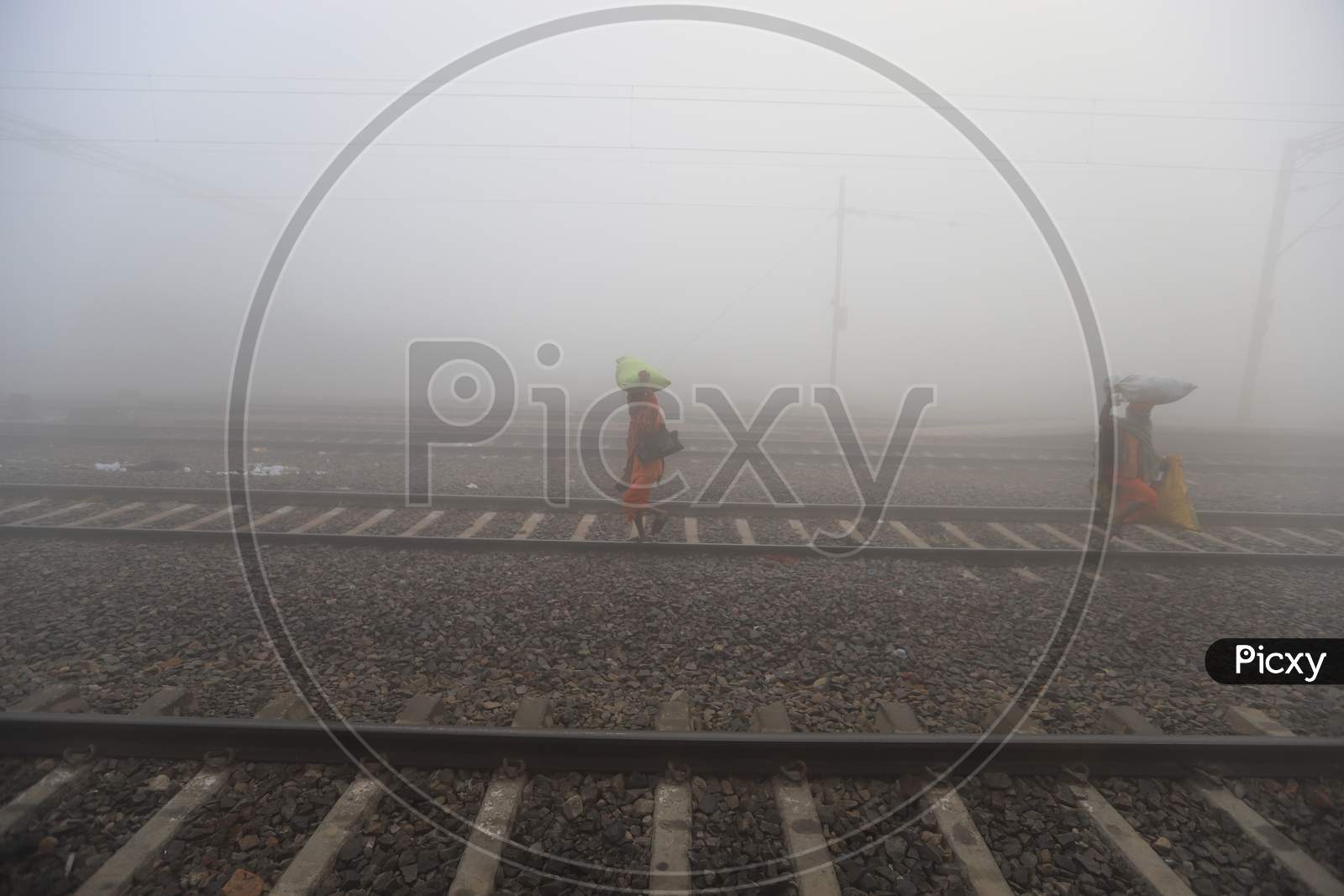 Passengers in an Railway Station Platform In an Misty Winter Morning