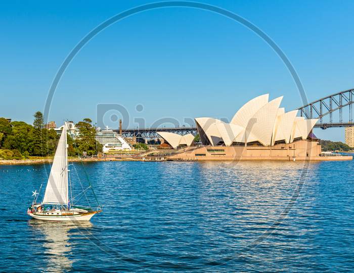 Sydney Opera House And A Yacht In The Harbour - Australia