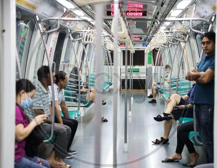 metro train with people waiting.