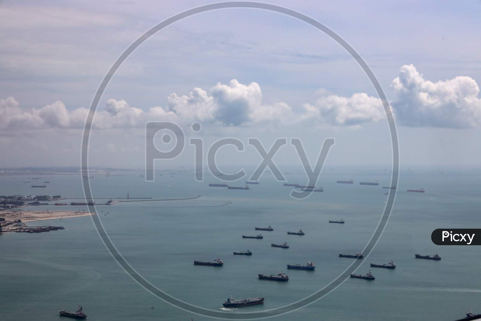 A View Of Cargo Ships on Sea From Flight Window