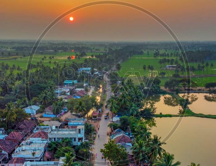 Aerial Shot of Sunset in a village with paddy fields in east godavari