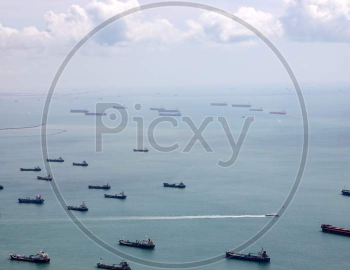 A View Of Cargo Ships on Sea From Flight Window