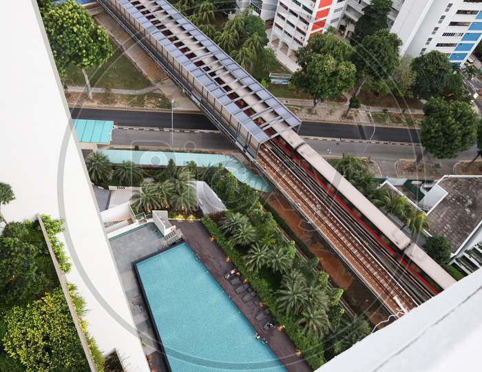 view of swimming pool and metro from an apartment in Singapore.