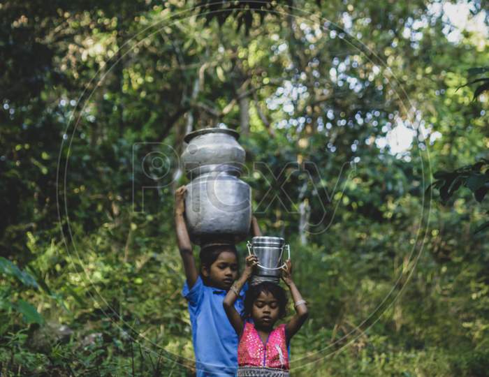 Rural Village Girls Carrying Water In Vessels over Head