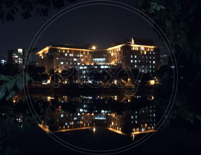 Reflection of an Building On Night Lights And Its Reflection On Lake Water Surface