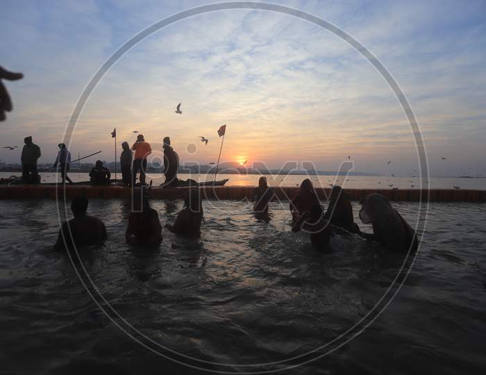 Silhouette of Crowd Of Hindu Devotees  And Sadhu  Taking Holy Bath In Triveni Sangam River At  Prayagraj  During  Magh Mela 2020 in Allahabad