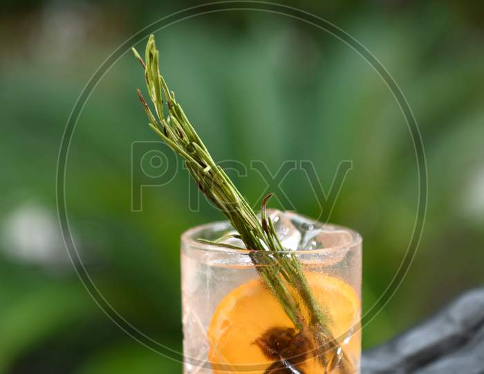 Mocktail Glass With Ice , Lime And  Rosemary