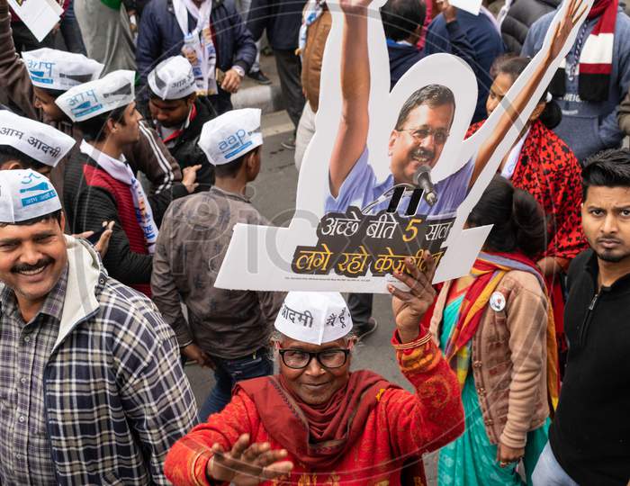 Aam Aadmi Party AAP supporter holding cutout of Arvind Kejriwal during a rally for Delhi Assembly Election