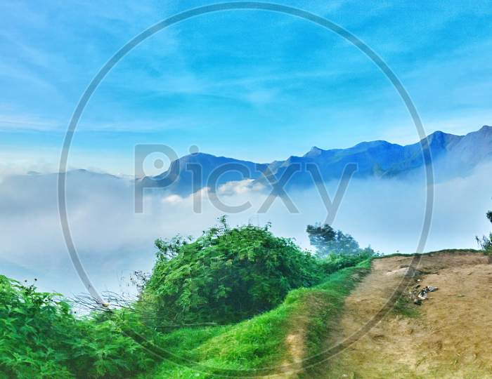 Landscape Of Terrains And   Clouds  With Blue Sky As Background