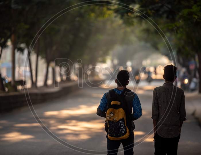 College Students With Bags In an Urban City Road