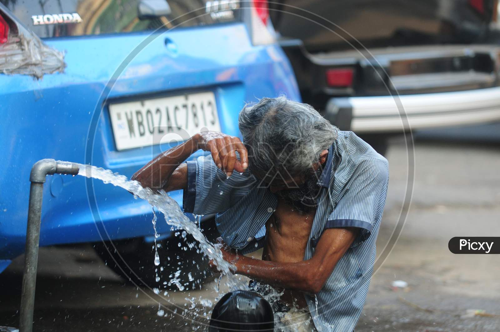 Indian Man washing his body by the tap