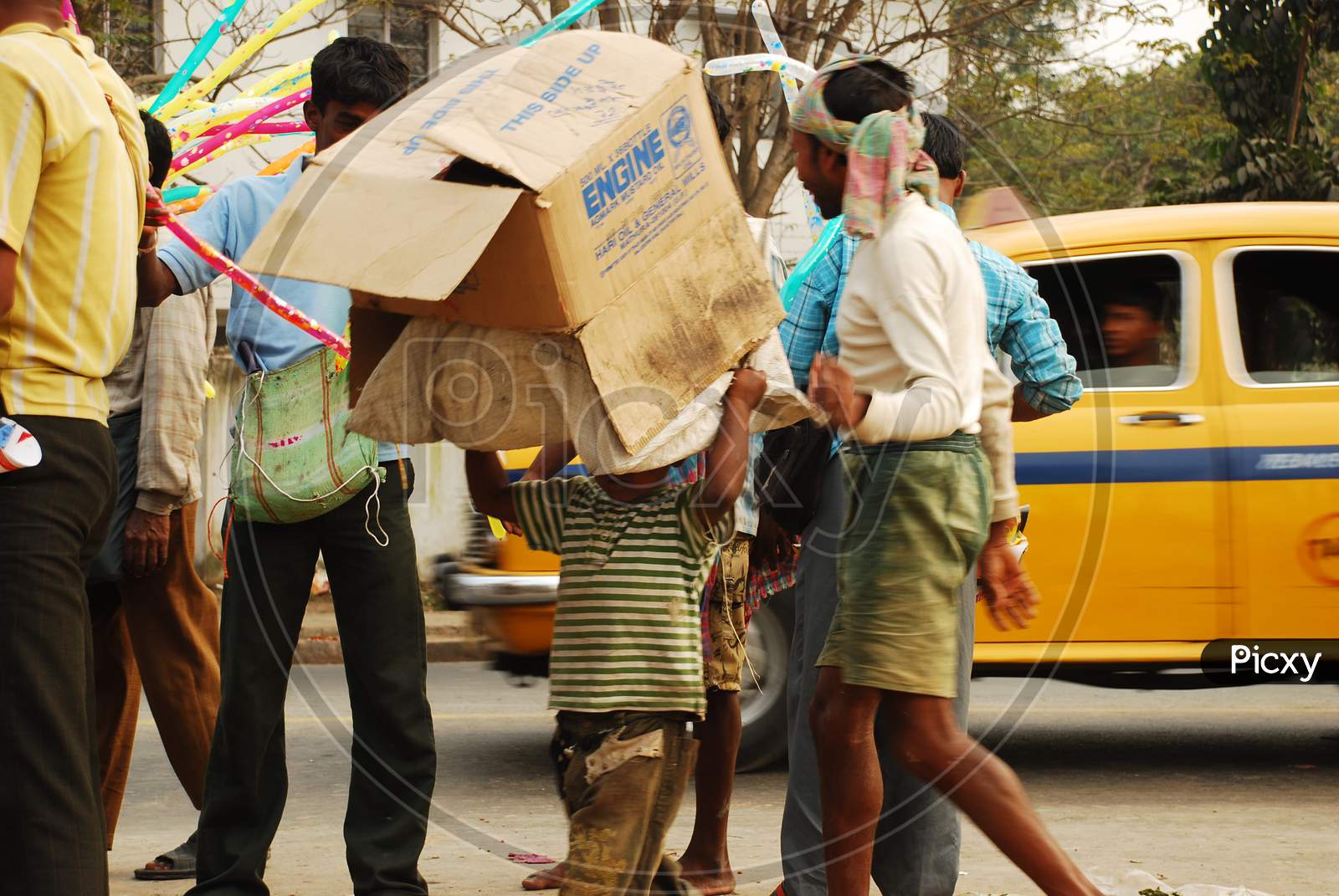 Indian little boy carrying coagulated box