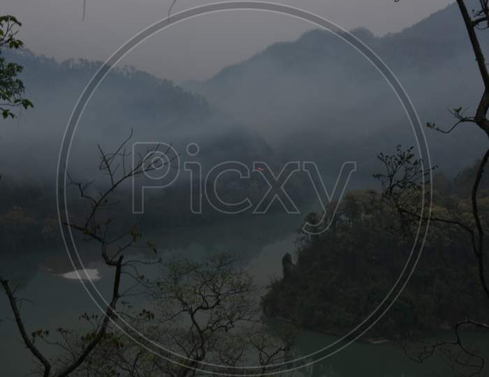 View of mountains covered in fog