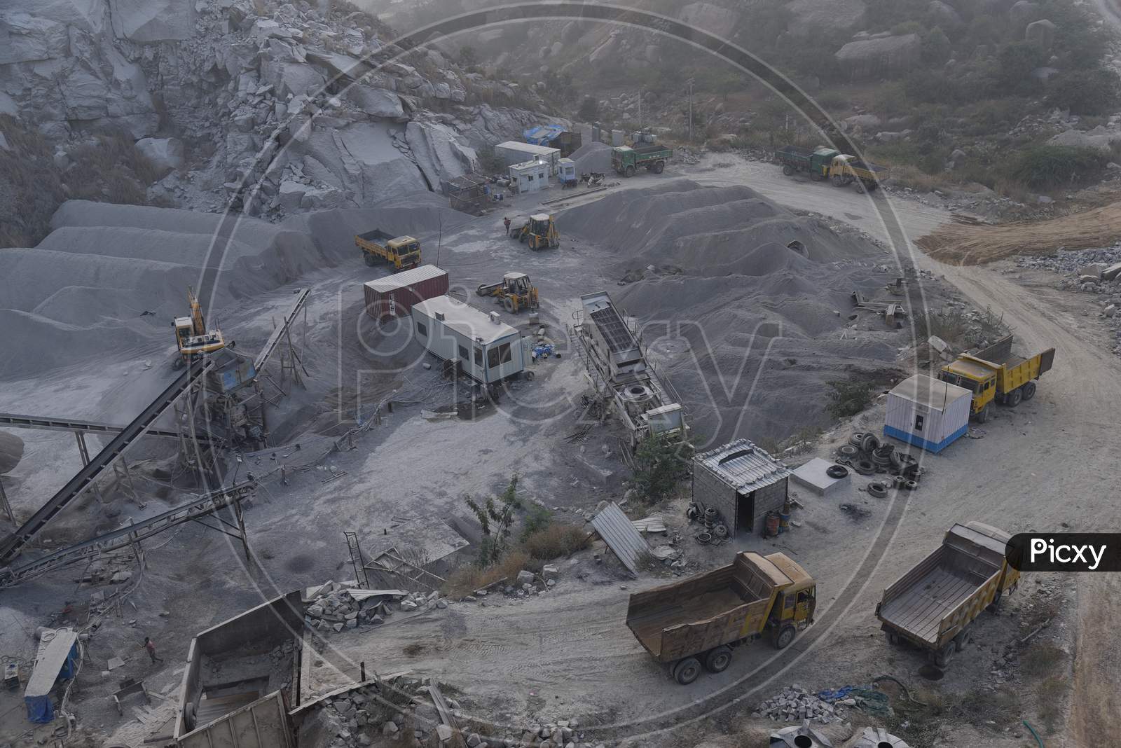 Aerial View of Stone Crushing Industry With Heavy Trucks And Proclainers Working  At Kajaguda, Hyderabad