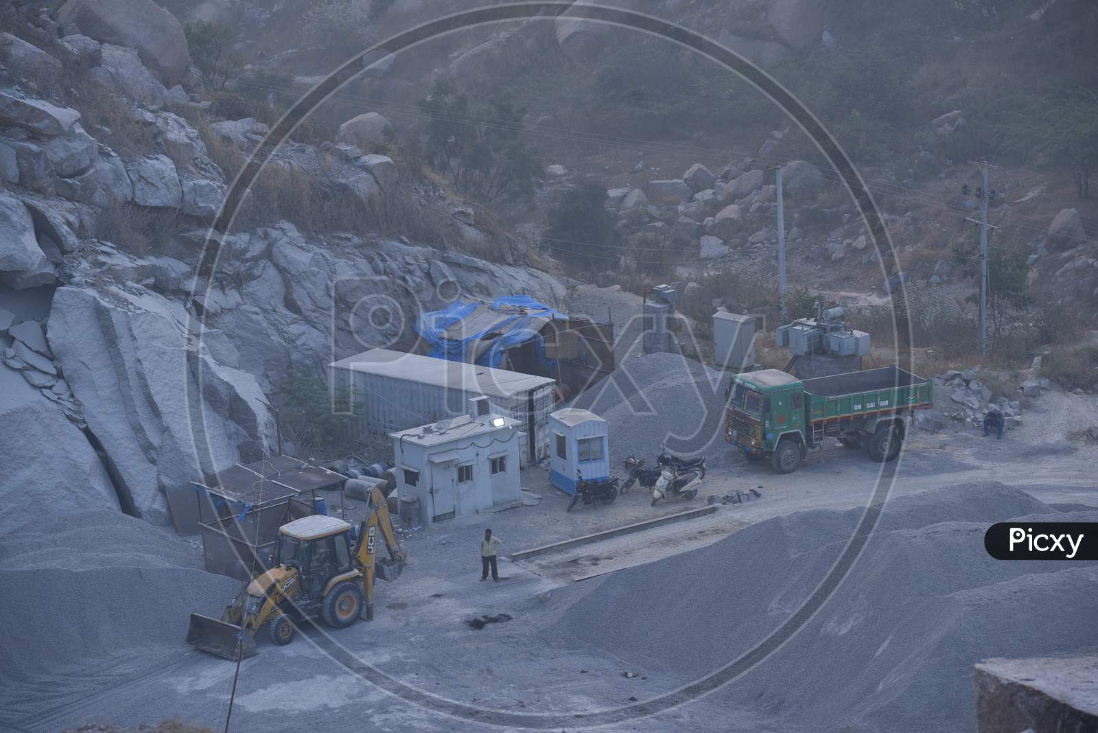 Aerial View of Stone Crushing Industry With Heavy Trucks And Proclainers Working  At Kajaguda, Hyderabad