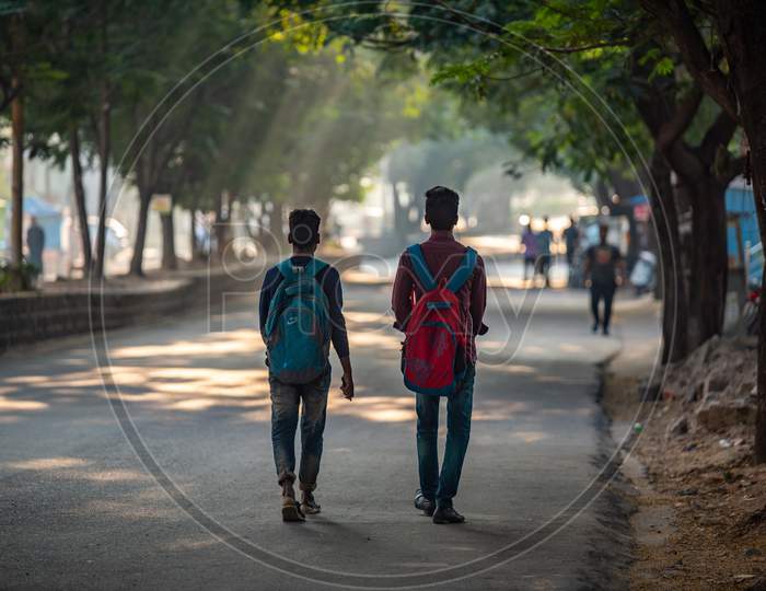 College Students With Bags Walking on  Urban City Road