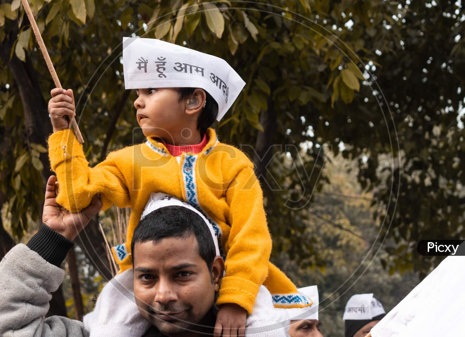 A child wearing a cap, supporting Aam Aadmi Party, during a campaign by AAP party for Delhi Assembly Election