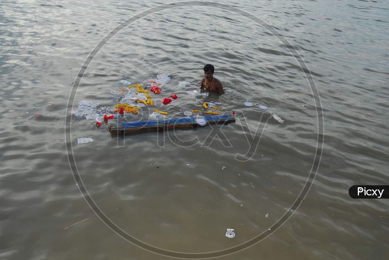 Indian man taking a dip in the river