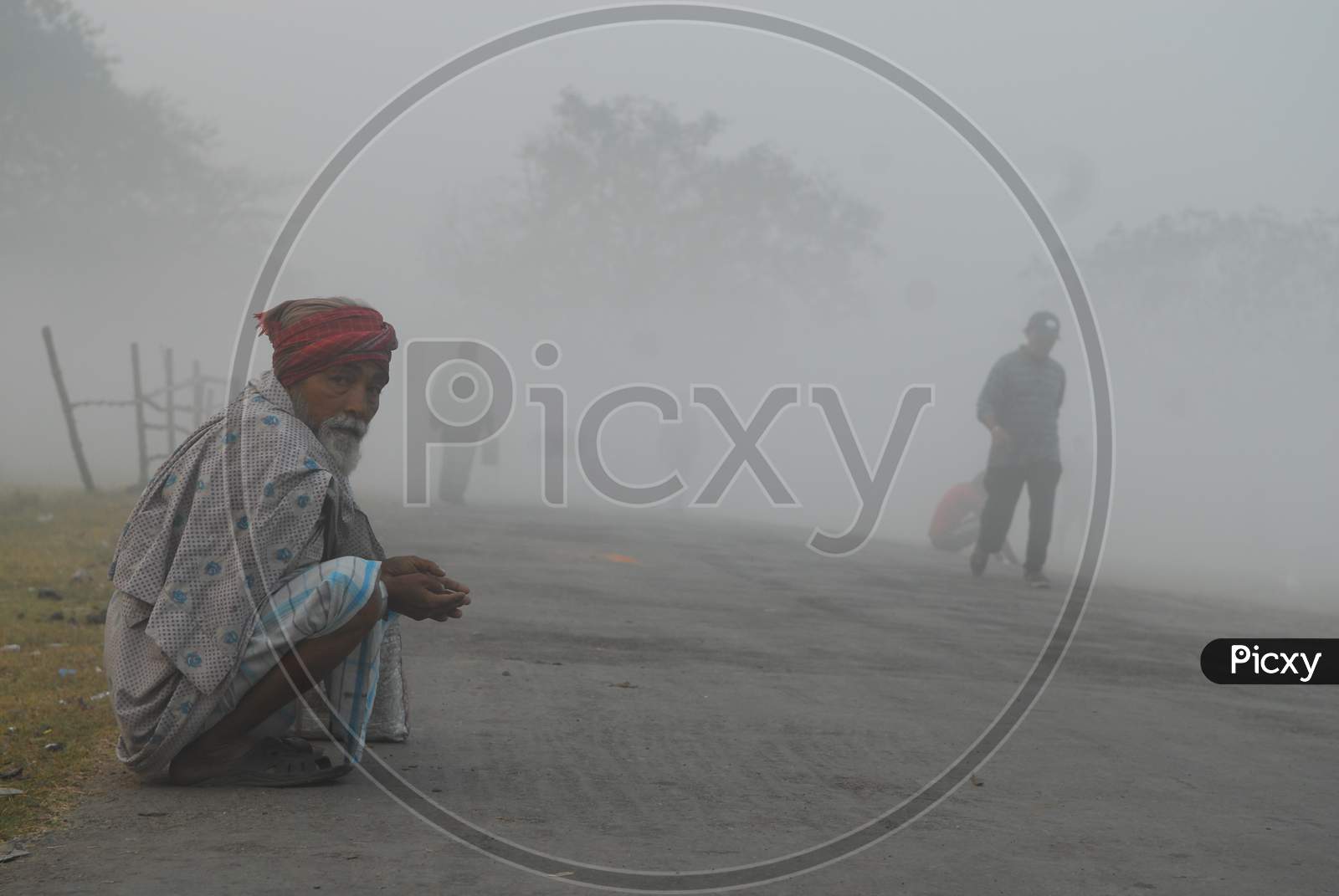 Indian old man experiencing heavy fog