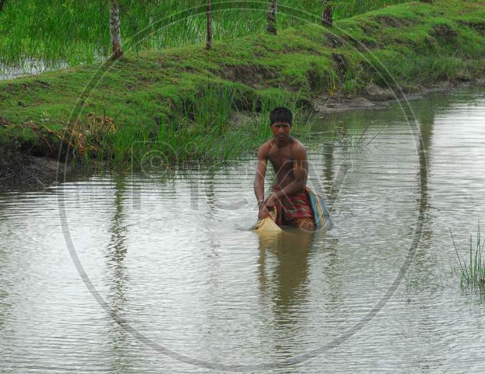A Fisherman Fishing In an Pond