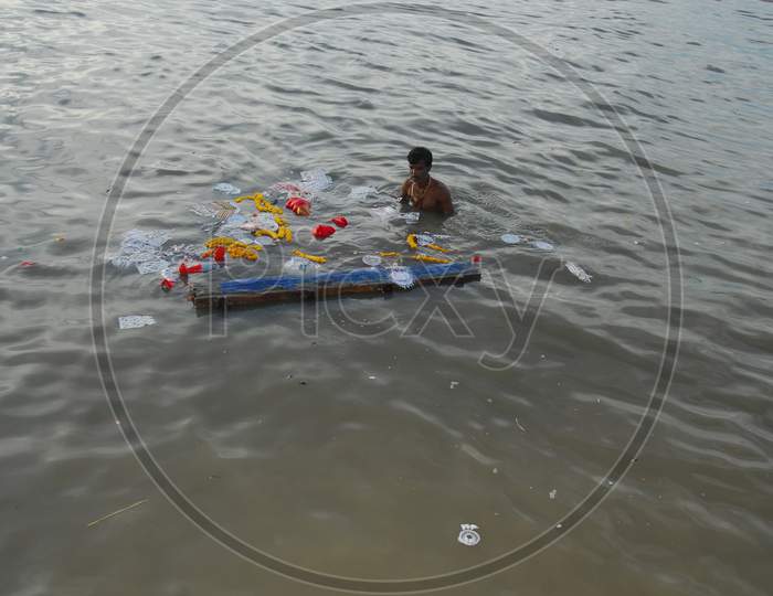 Indian man taking a dip in the river