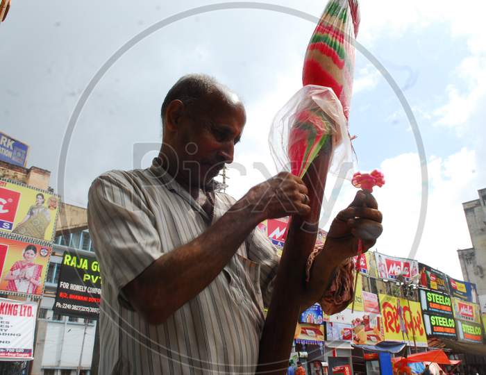 Indian man making shapes with Candy