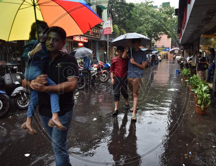 People Walking On Roads Holding Umbrellas During Heavy Rain in Kolkata