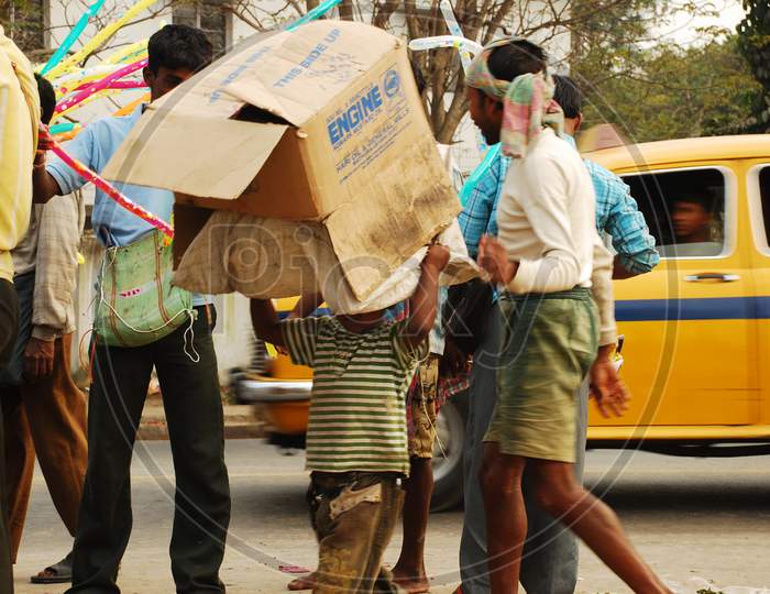 Indian little boy carrying coagulated box