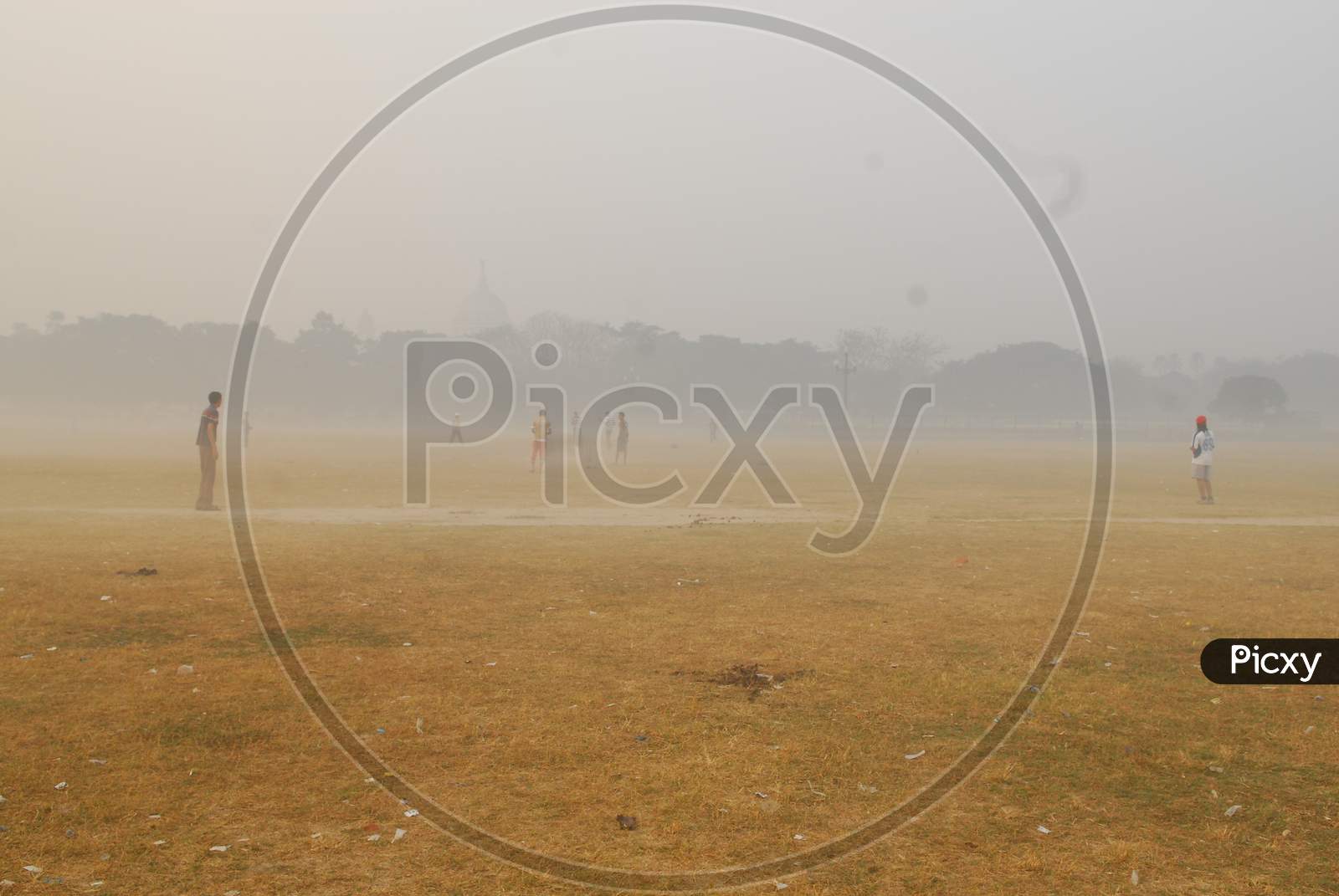 Young Man Playing In Ground On an Foggy Winter Morning