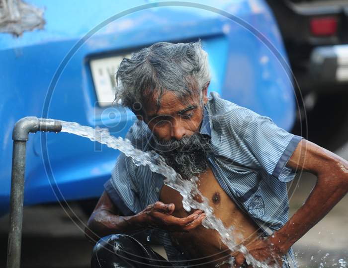 Indian Local Man taking a shower at Public tap