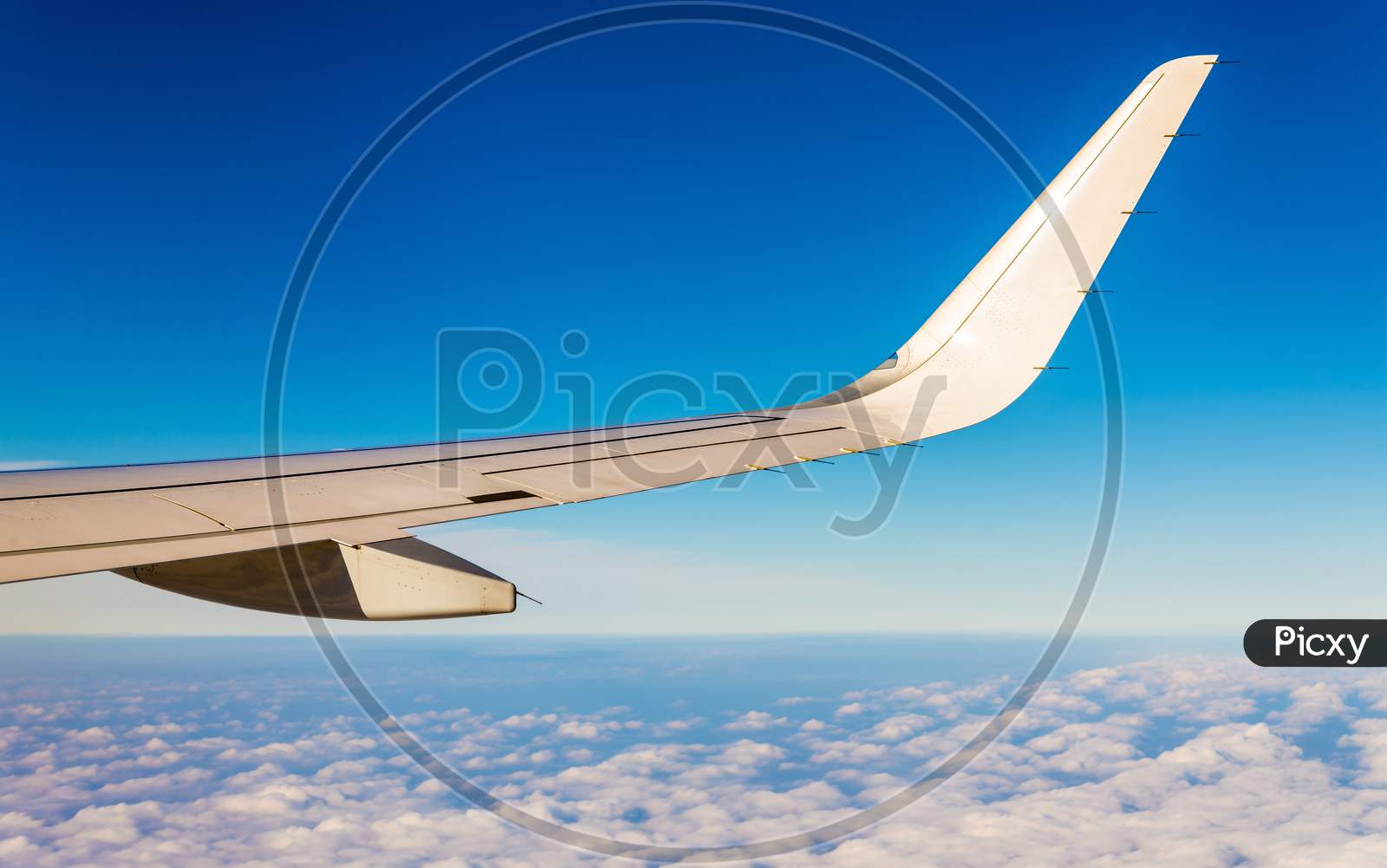 Aircraft Wing Flying Over Clouds