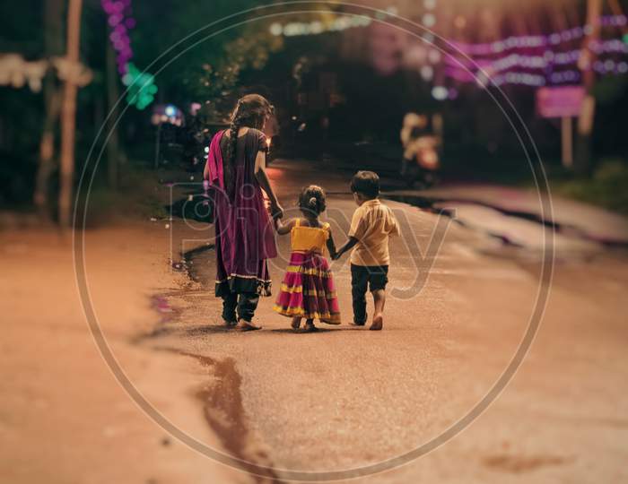 Mother With Her Children Walking in a n Streets of residential Area