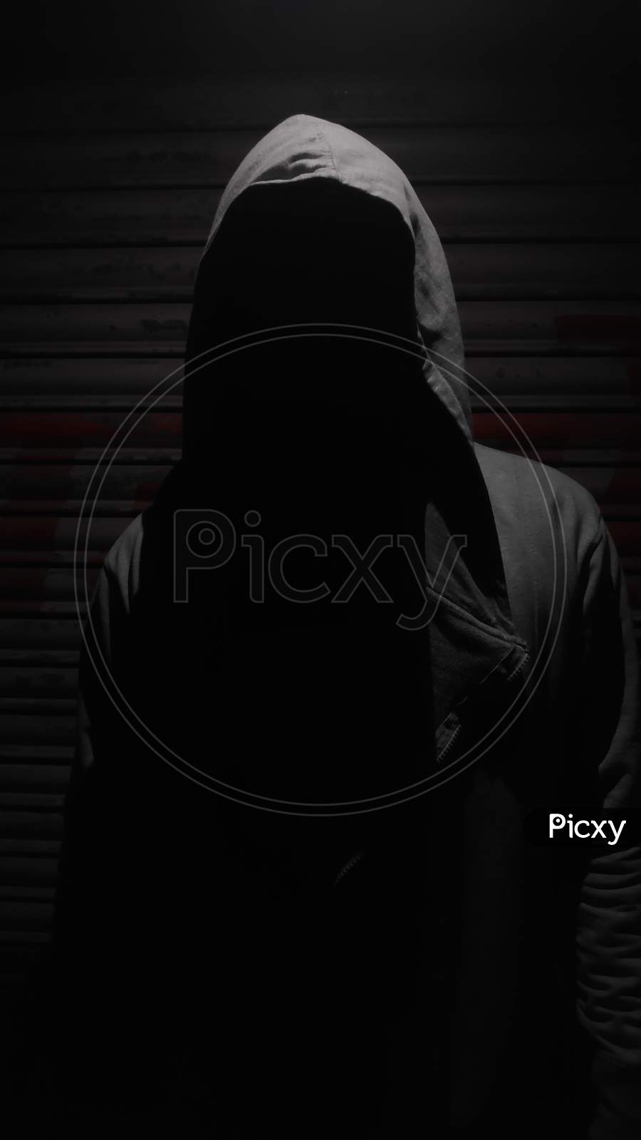 Silhouette of a man wearing a hoodie