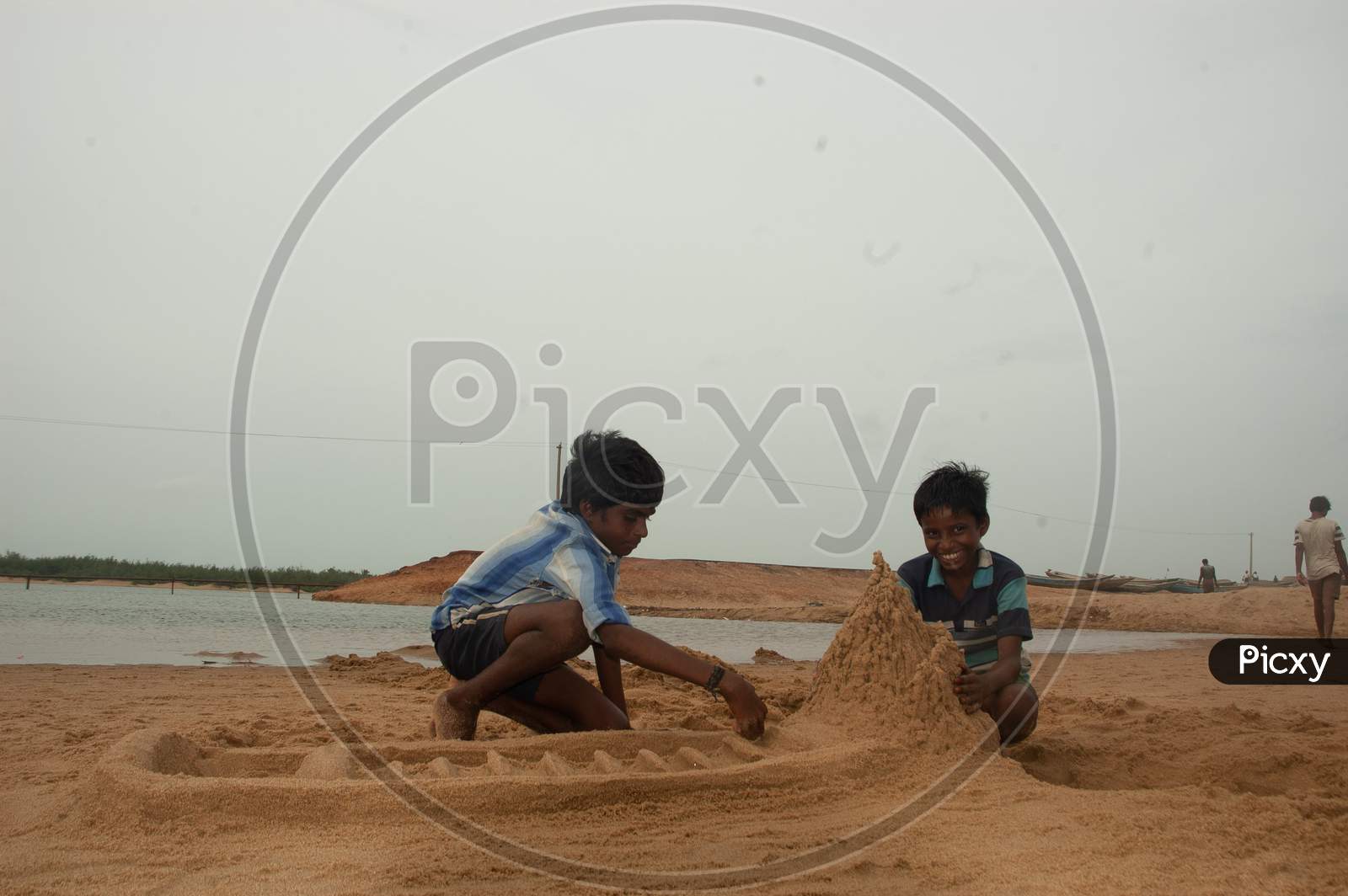 Indian local boys building sand castles