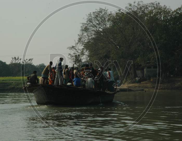 People Commuting On Wooden Boats At Murshidabad Over Hooghly River in West Bengal