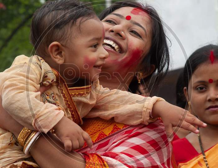 Indian Mother with her baby boy during Durga Puja
